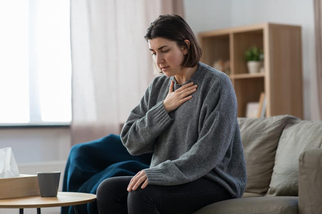 panic attack vs. heart attack - woman having trouble breathing or panic attack at home