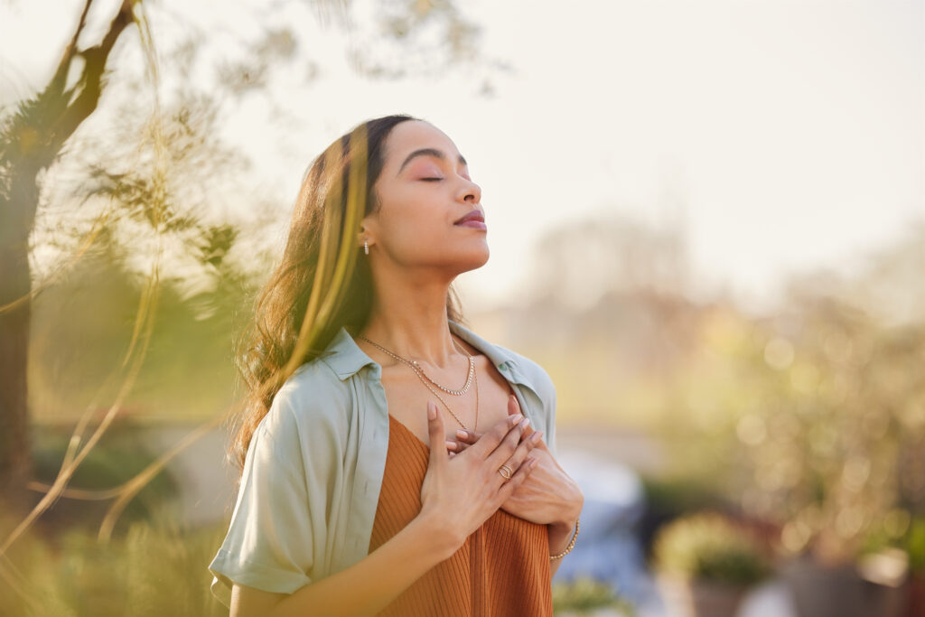 Mixed race woman relax and breathing fresh air outdoor at sunset Mixed race woman relax and breathing fresh air outdoor at sunset