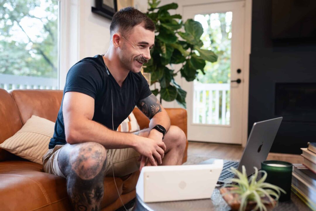 Young man using the Freespira treatment in his living room