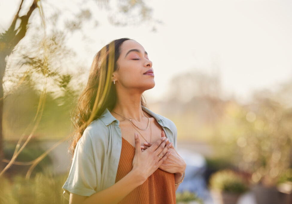 Mixed race woman relax and breathing fresh air outdoor at sunset