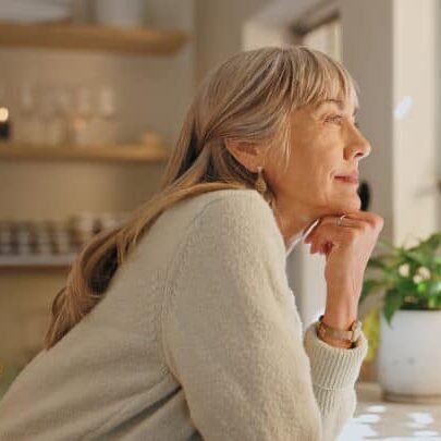 Window, smile and elderly woman with thinking at home for retirement, satisfaction and peace on weekend. Relax, senior person and calm with idea for reflection, mindfulness and good memory in house