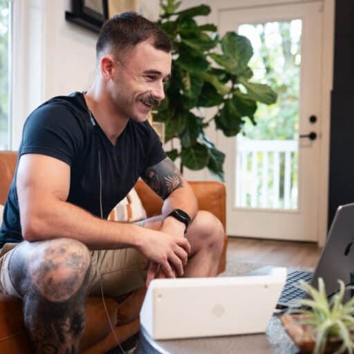 Young man using the Freespira treatment in his living room