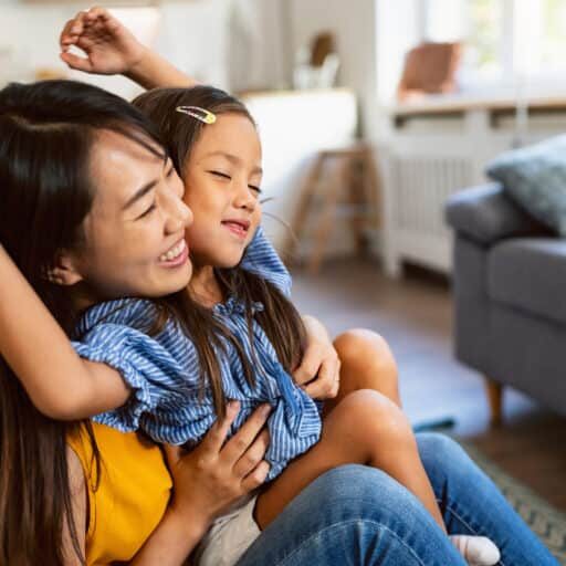 Woman and her daughter embracing and showing affection and love to each other