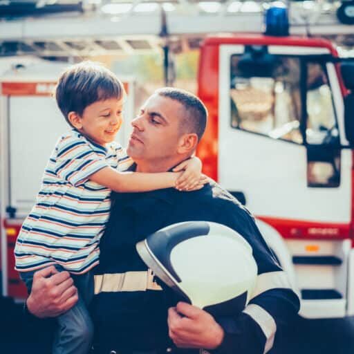 Firefighter with smiling boy after successful rescue operation