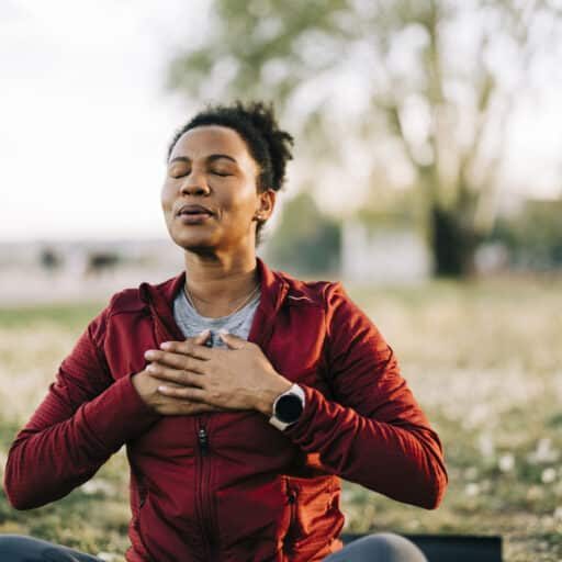 Woman, breath and hand on chest, for meditation and wellness being peaceful to relax.
