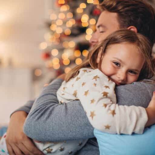 Father and his cute daughter in front of christmas three