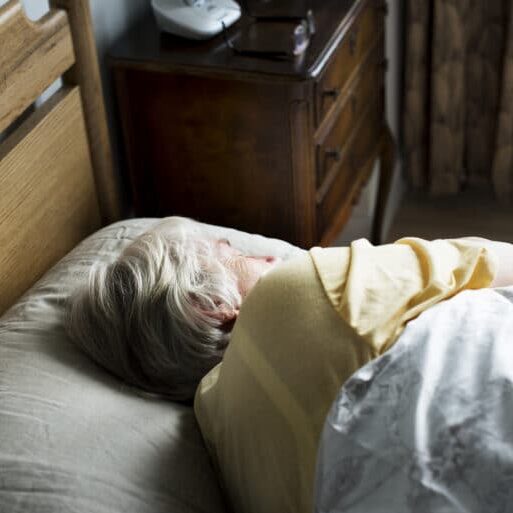 Elderly caucasian woman sleeping on the bed