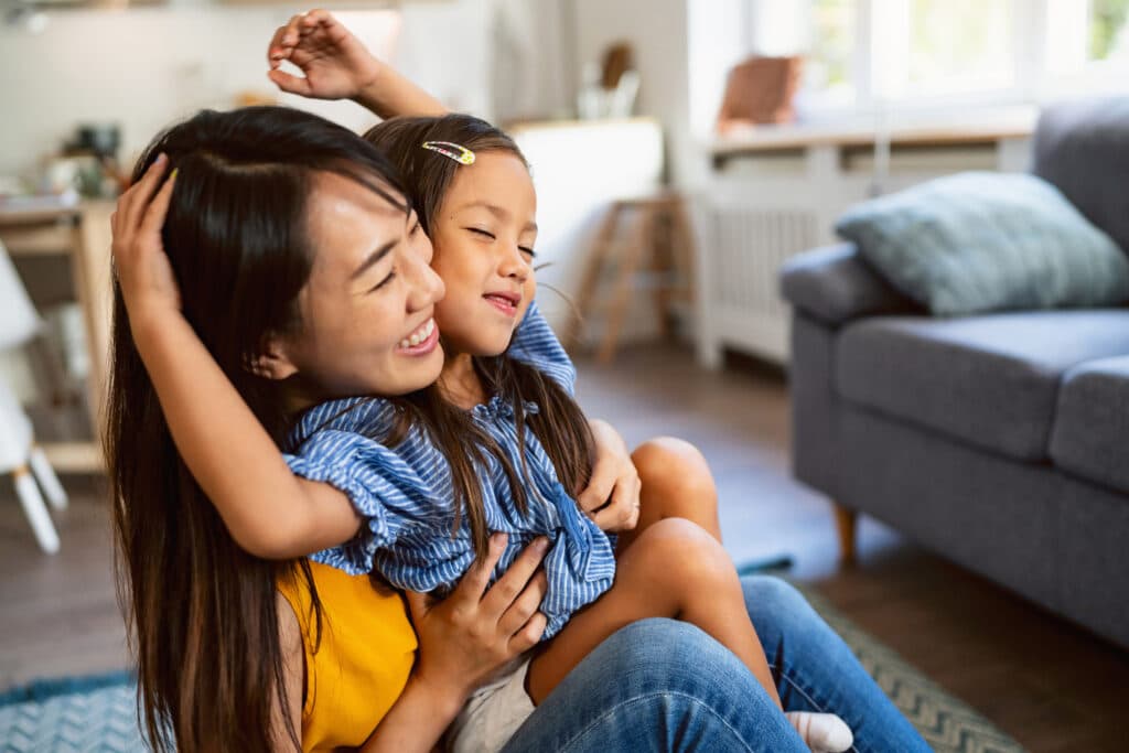 Woman and her daughter embracing and showing affection and love to each other