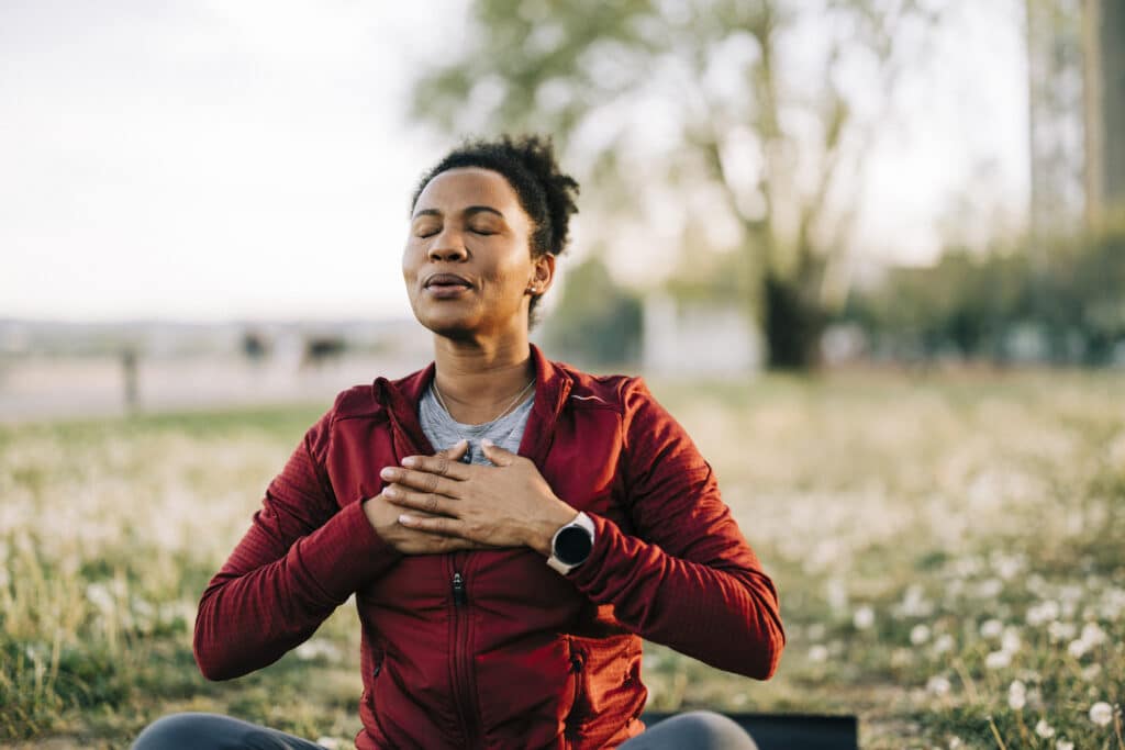 Woman, breath and hand on chest, for meditation and wellness being peaceful to relax.